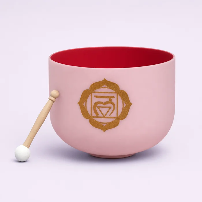 The C note single bowl in pale pink frosted quartz with a red interior, engraved with a gold root chakra symbol, resting beside its wooden mallet